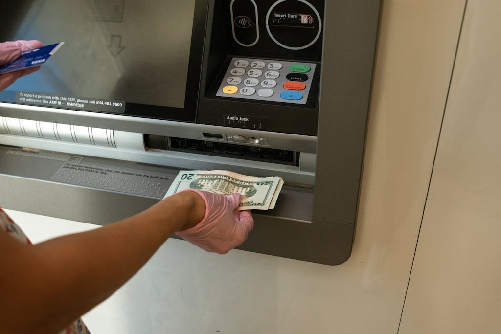 Person Deposits Money on an ATM